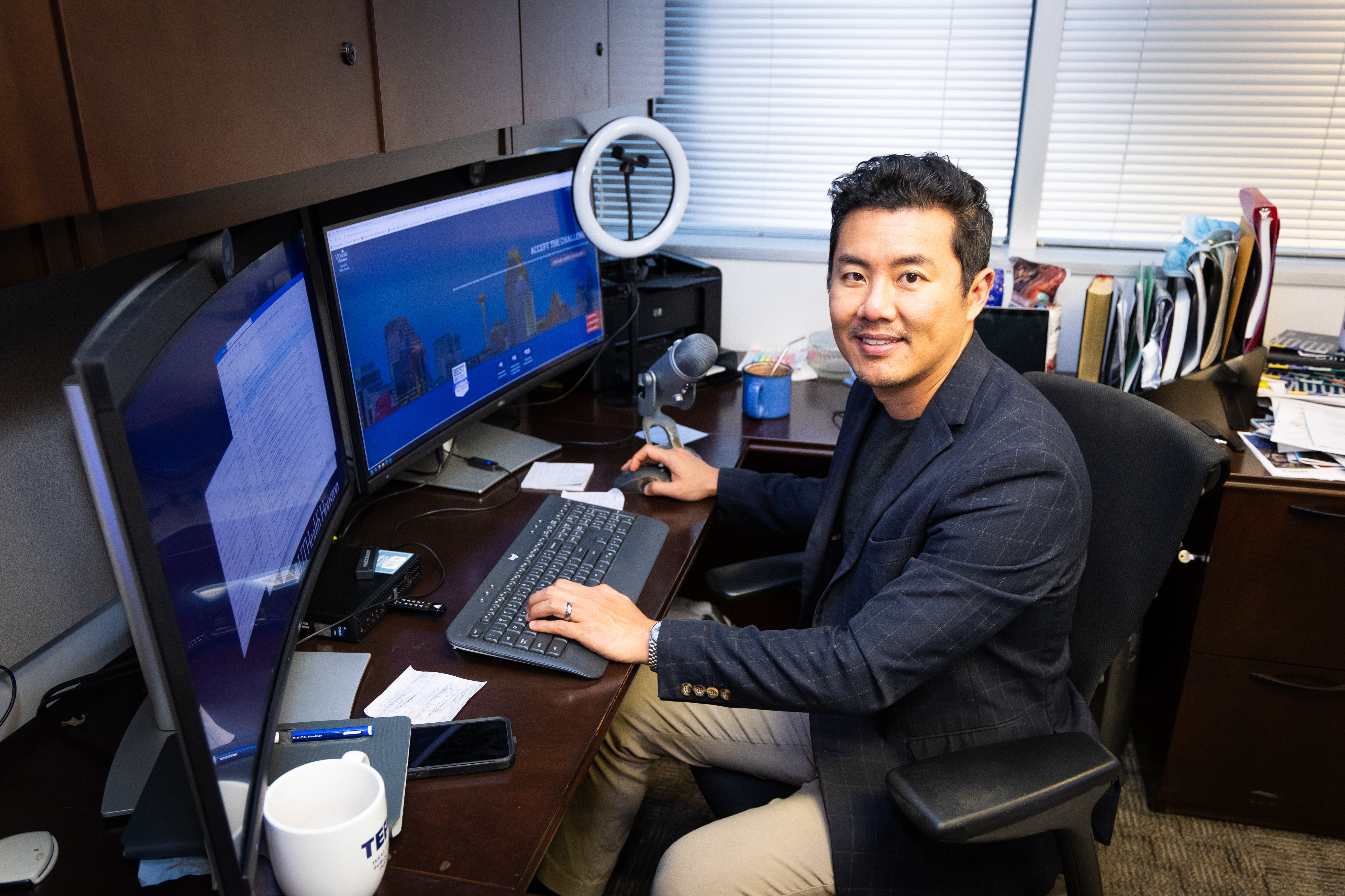 Jack Tsai, PhD, professor at UTHealth Houston School of Public Health sits at his desk.