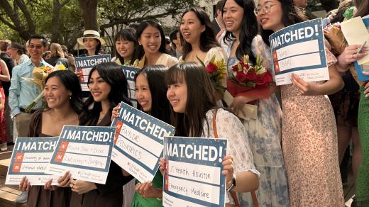 Group photo of students holding Match Day signs