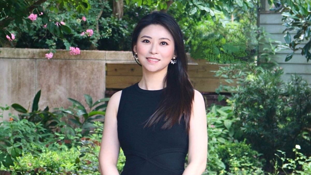 Yun Hang, PhD, in front of Holistic Garden.