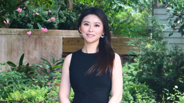 Yun Hang, PhD, in front of Holistic Garden.