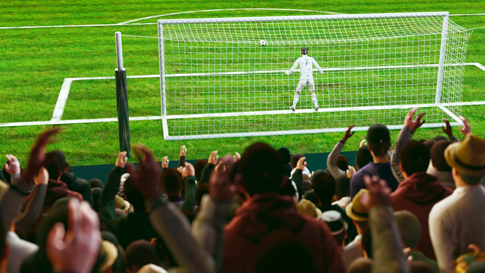 Image of soccer pitch with fans in main focus and goalie and post in foreground.