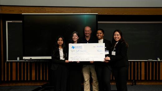 5 people smiling at the camera holding winning check from the fleming center case competition