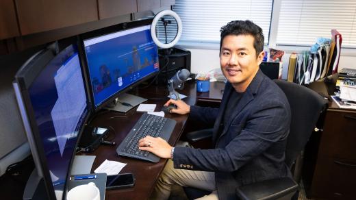 Jack Tsai, PhD, professor at UTHealth Houston School of Public Health sits at his desk.