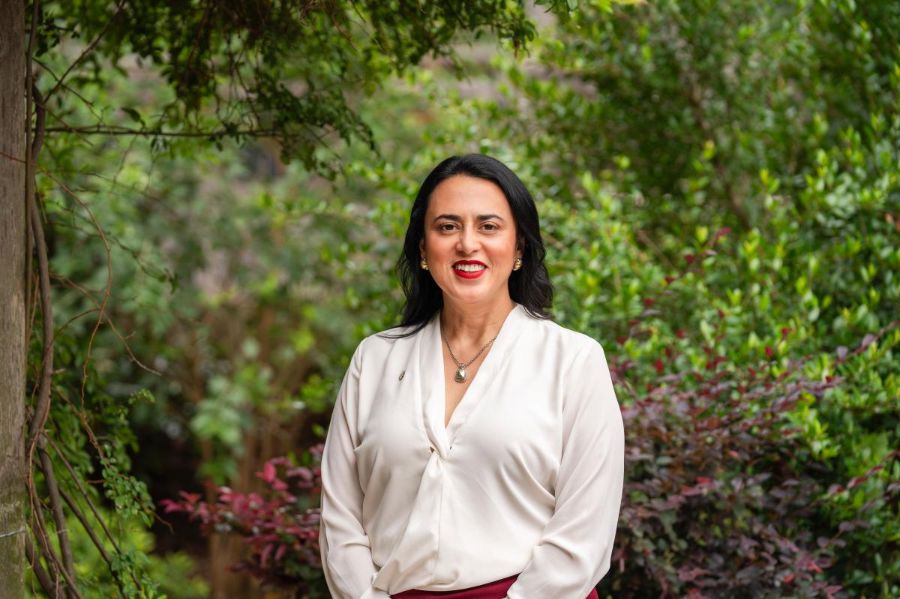 Ginger Raya pictured in front of full trees.